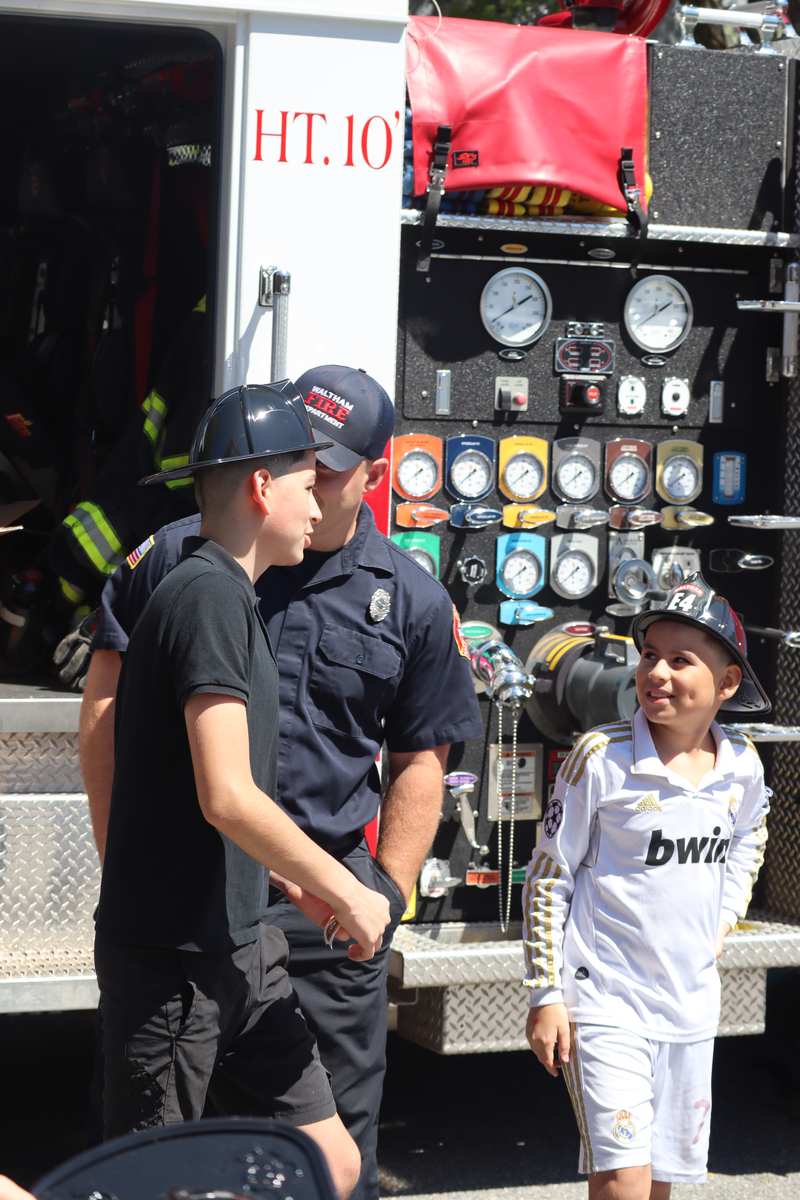 Children meeting the Waltham Fire Department at a Revive City community event
