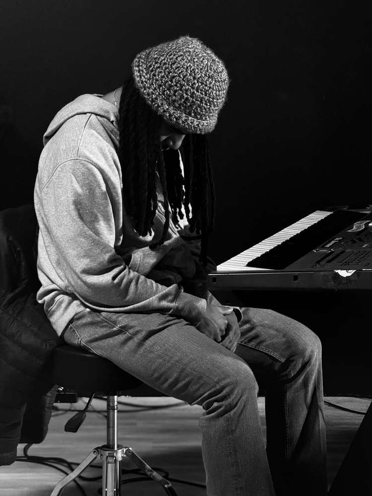 Musician praying at the keyboard before service