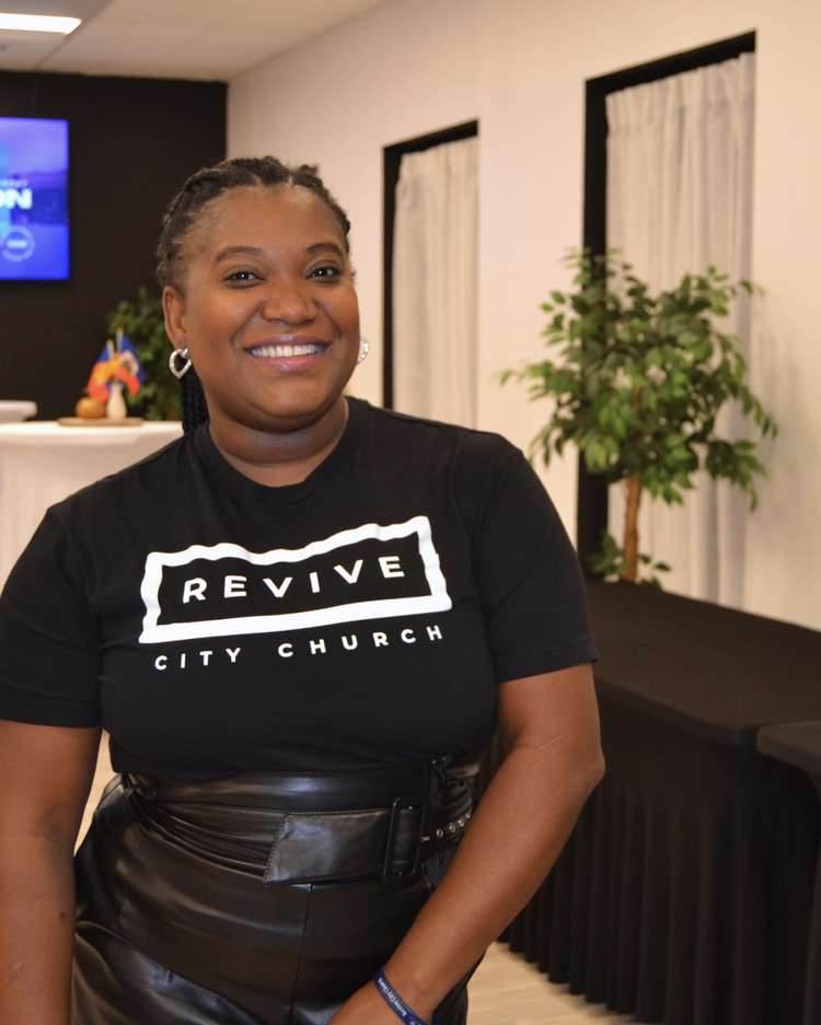 A greeter in a Revive City Church shirt in the lobby