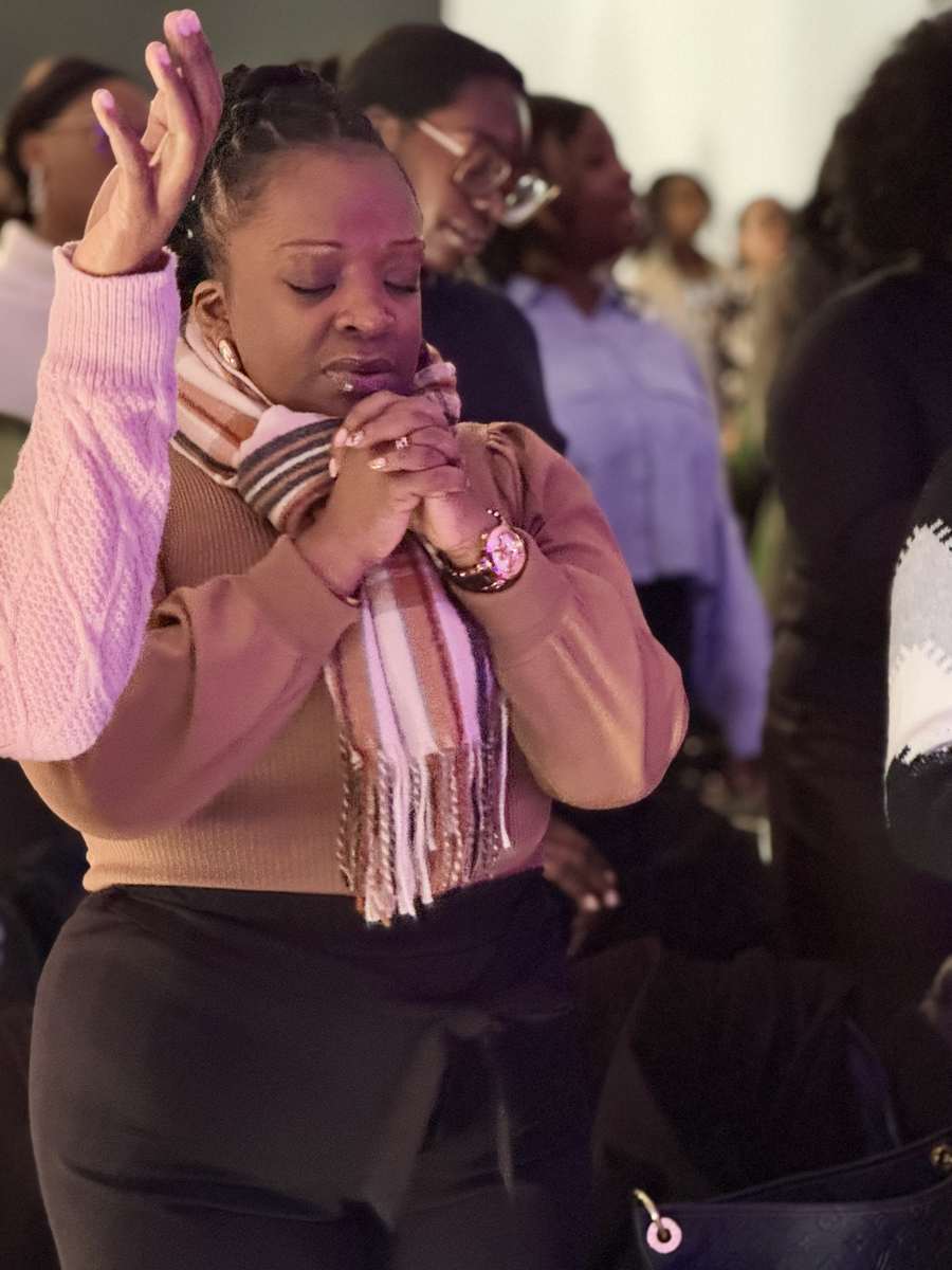 A woman praying during a Revive City service